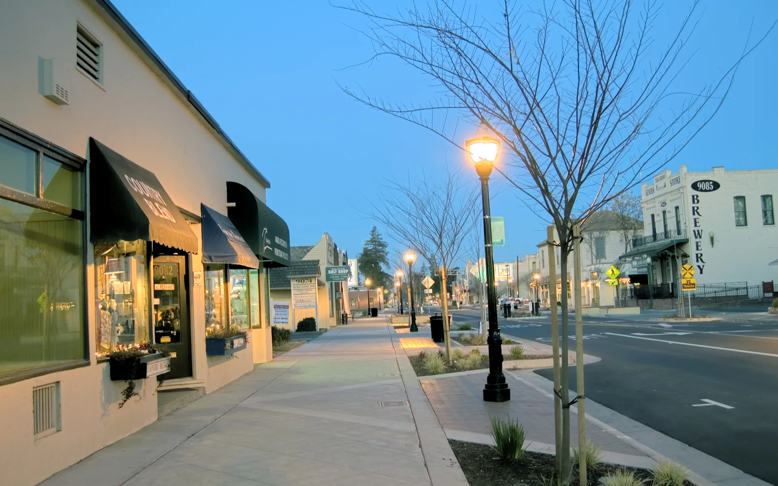 Old Town Elk Grove storefronts and streetlights at dusk